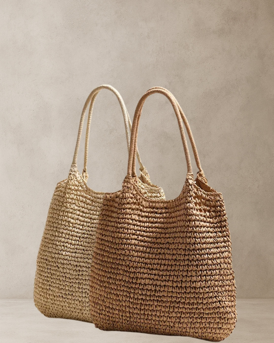 Coastal Raffia Tote Bags – Beige and Tan side by side; straw tote bags with inner lining and magnetic clasp; lightweight coastal accessories.