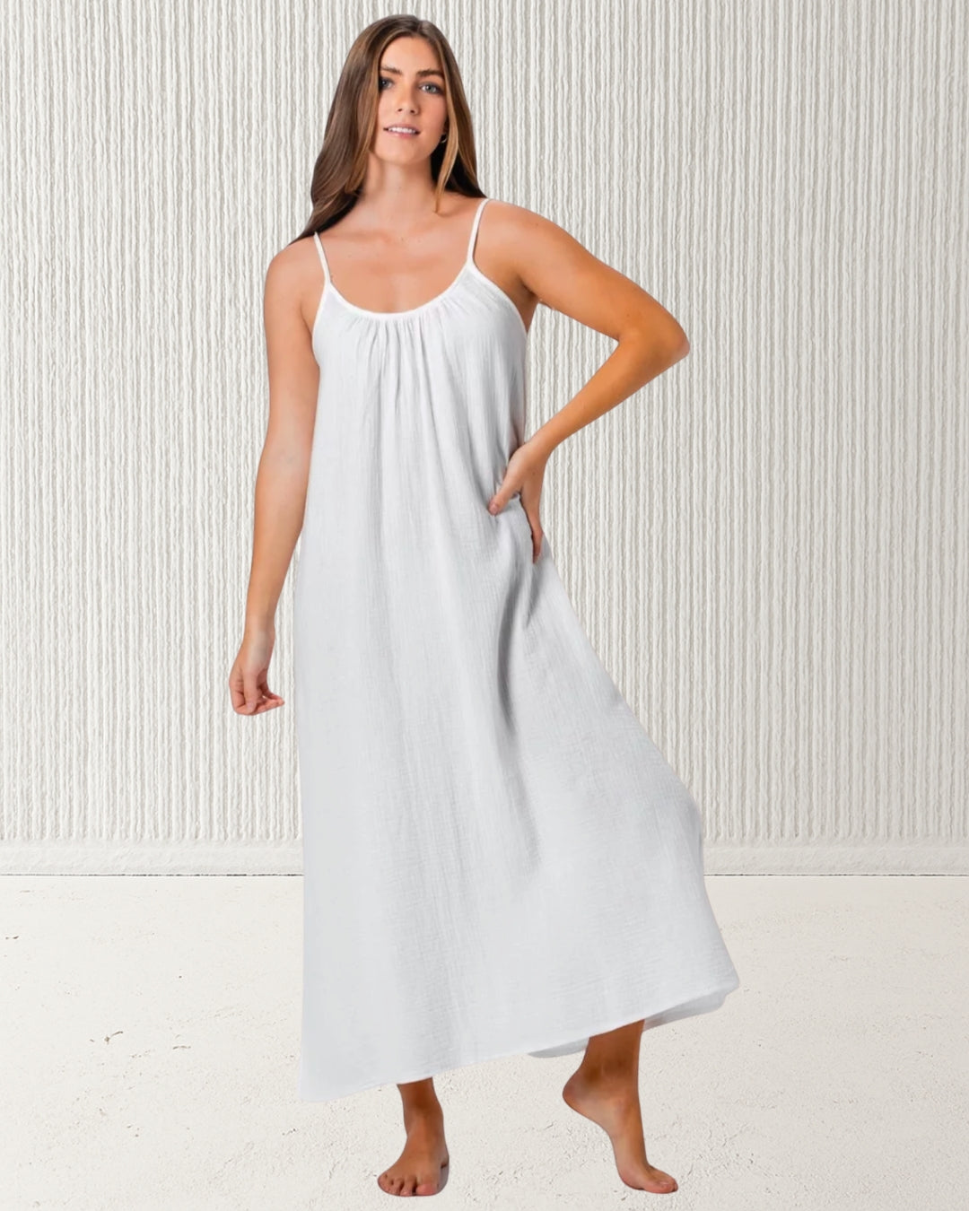 Isla Dress White – women’s 100% cotton muslin (cheesecloth) midi dress with spaghetti straps and relaxed fit. Lightweight, breathable summer style by Pastel & Earth.
