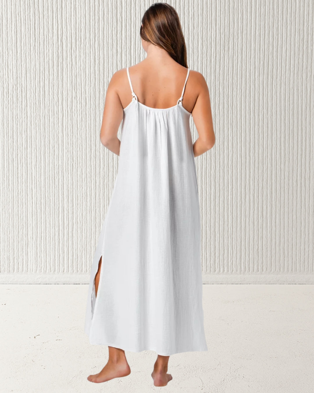 Isla Dress White – back view showing adjustable spaghetti straps and relaxed drape of 100% cotton muslin (cheesecloth) midi dress. Pastel & Earth summer style.