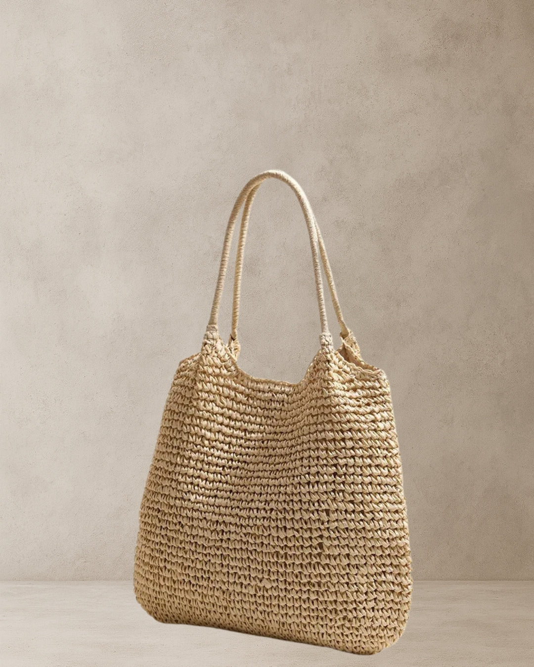 Coastal Raffia Tote Bag – Beige side view; raffia-style straw tote with soft handles and relaxed silhouette; everyday coastal bag.