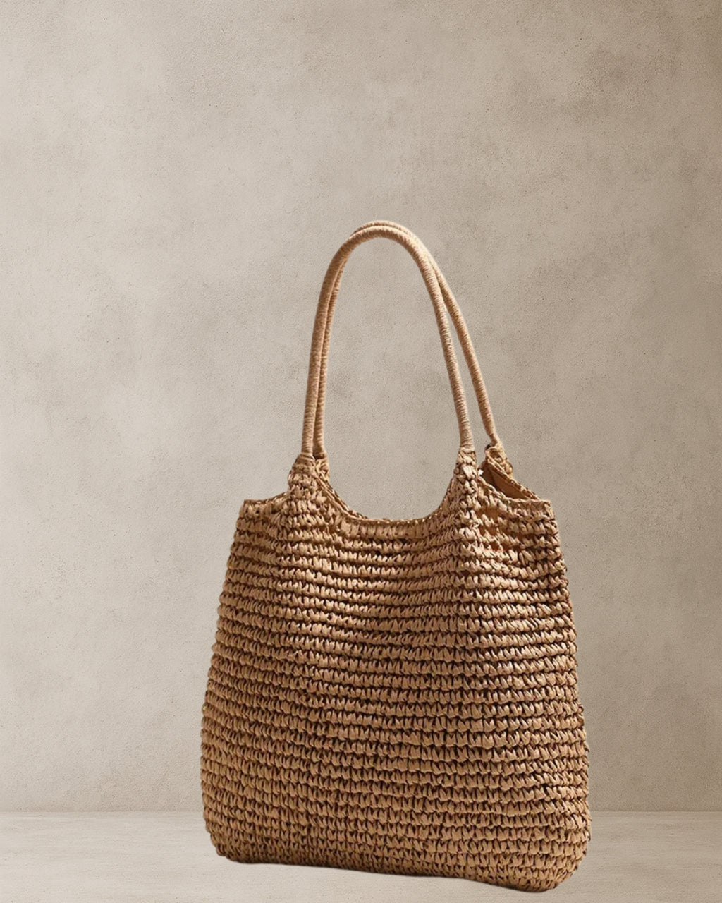 Coastal Raffia Tote Bag – Tan side view; raffia-style straw tote with soft shoulder handles and relaxed shape; market and weekend bag.