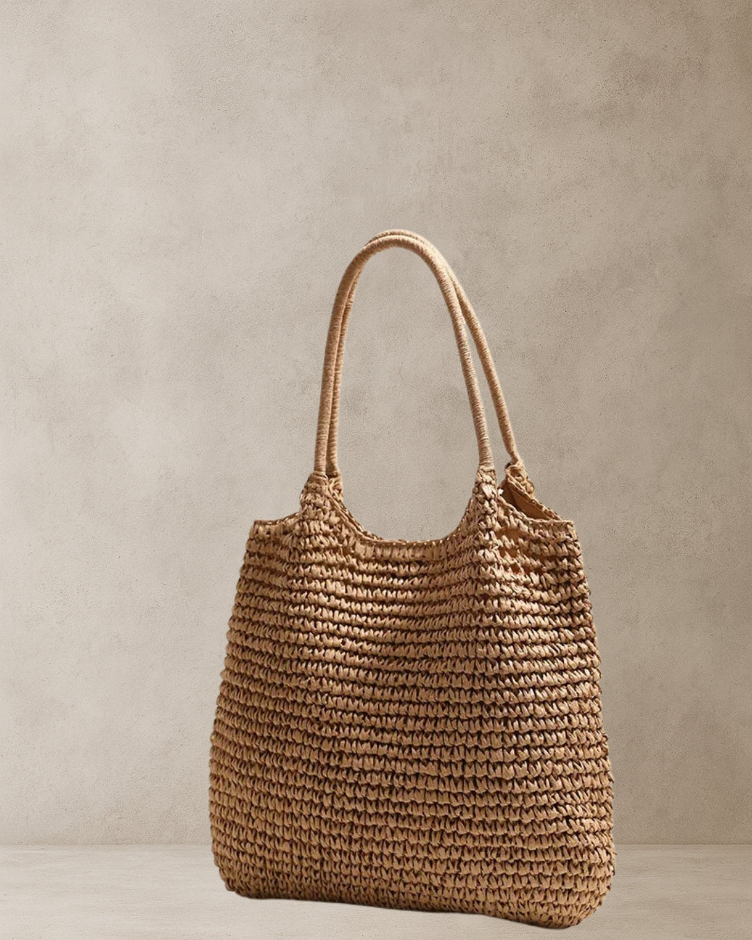 Coastal Raffia Tote Bag – Tan side view; raffia-style straw tote with soft shoulder handles and relaxed shape; market and weekend bag.