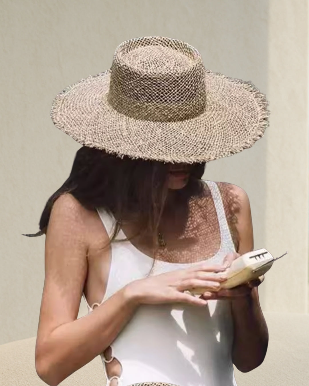 Coastal Rattan Wide Brim Straw Hat on model; natural rattan straw sun hat for beach and resort weekends.