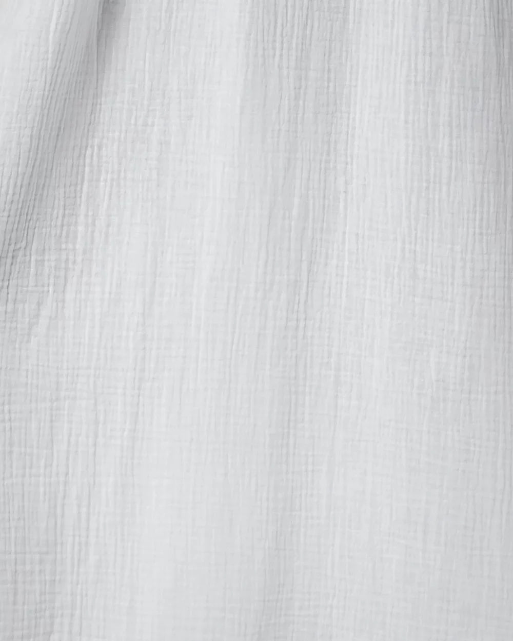 Isla Dress White – close-up detail of 100% cotton muslin (cheesecloth) fabric texture. Soft, breathable material by Pastel & Earth.
